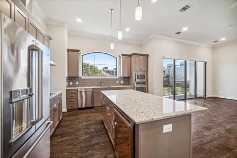 a kitchen with stainless steel appliances granite countertop a sink stove and refrigerator