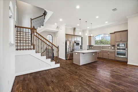 a view of kitchen with wooden floor and electronic appliances