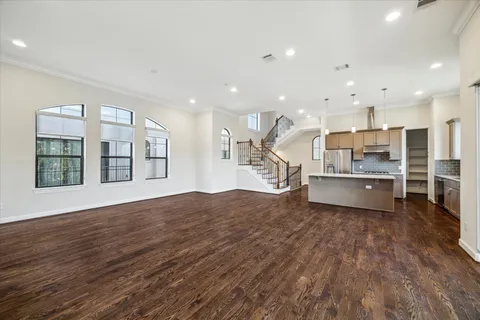 a view of kitchen with kitchen island wooden floor and center island