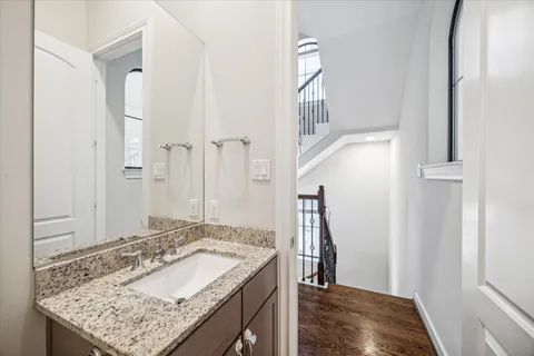 a bathroom with a granite countertop sink and a mirror