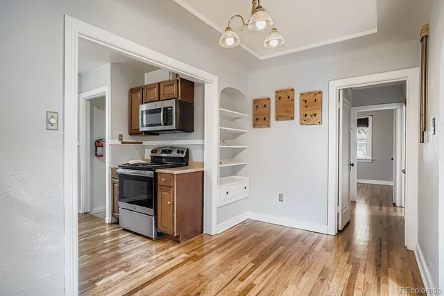a view of kitchen with granite countertop cabinets and stainless steel appliances
