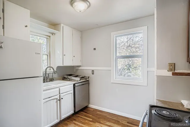 a kitchen with a stove cabinets and a refrigerator