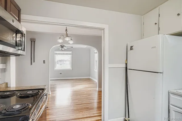 a white refrigerator freezer and a stove sitting inside of a kitchen