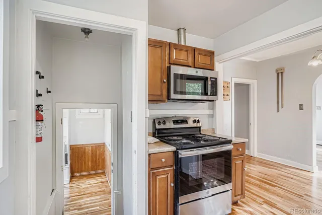 a kitchen with stainless steel appliances a stove a microwave and a refrigerator