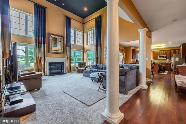 a living room with furniture large window and a fireplace