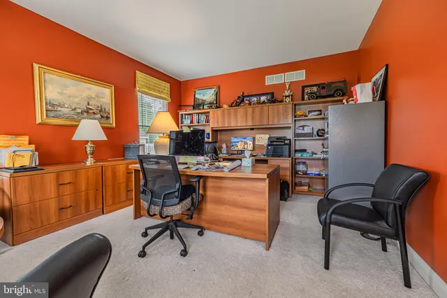 a work room with furniture and a ceiling fan