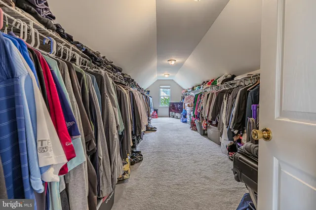 a view of walk in closet with clothes
