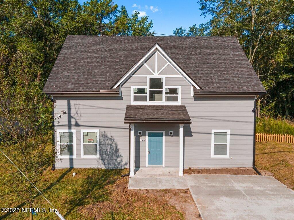 11816 Lem Turner Road Jacksonville, FL 32218 - Photo 1 of 24 a front view of a house with a garden
