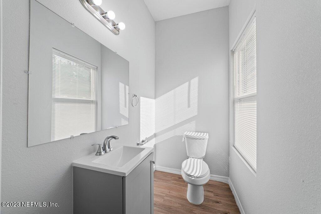 11816 Lem Turner Road Jacksonville, FL 32218 - Photo 12 of 24 a bathroom with a toilet a sink and mirror