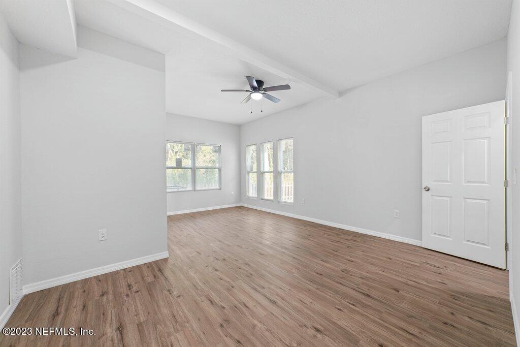 11816 Lem Turner Road Jacksonville, FL 32218 - Photo 13 of 24 wooden floor in an empty room with a window