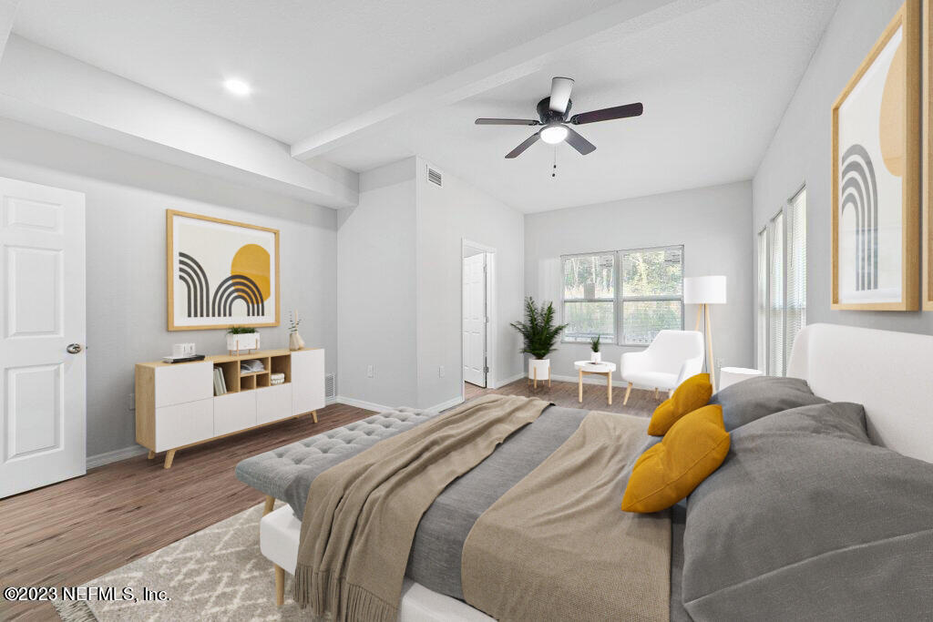 11816 Lem Turner Road Jacksonville, FL 32218 - Photo 14 of 24 a bedroom with a bed and wooden floor