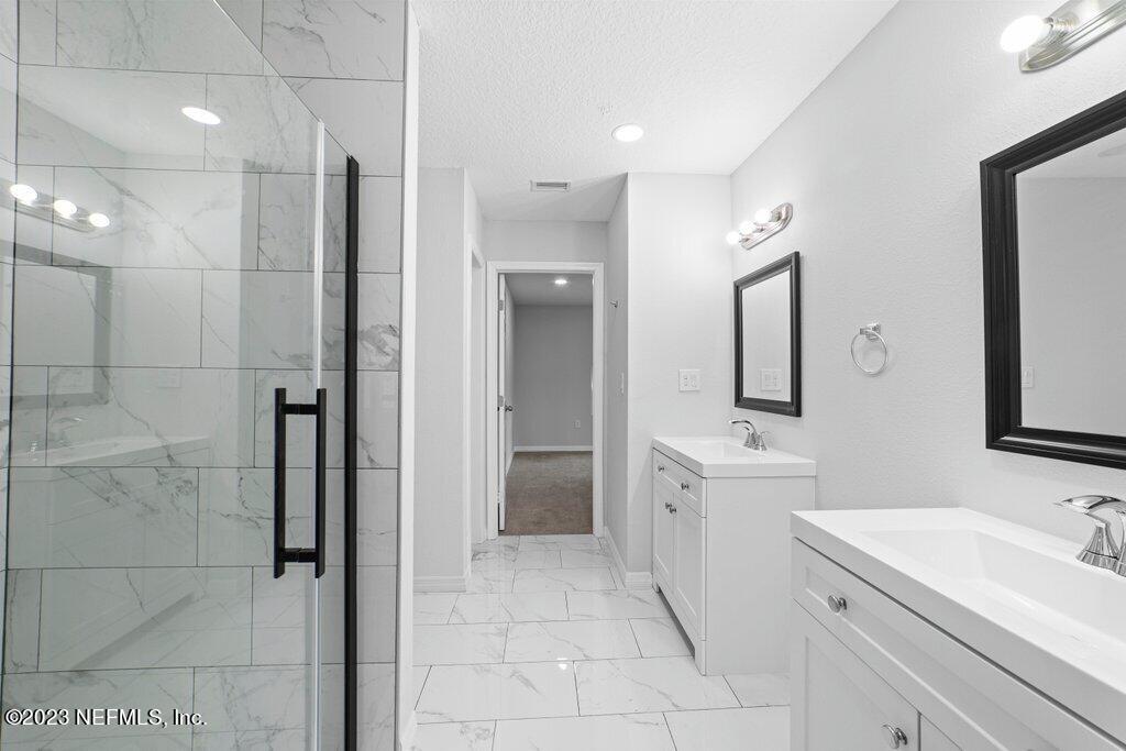 11816 Lem Turner Road Jacksonville, FL 32218 - Photo 20 of 24 a bathroom with a double vanity sink mirror and shower