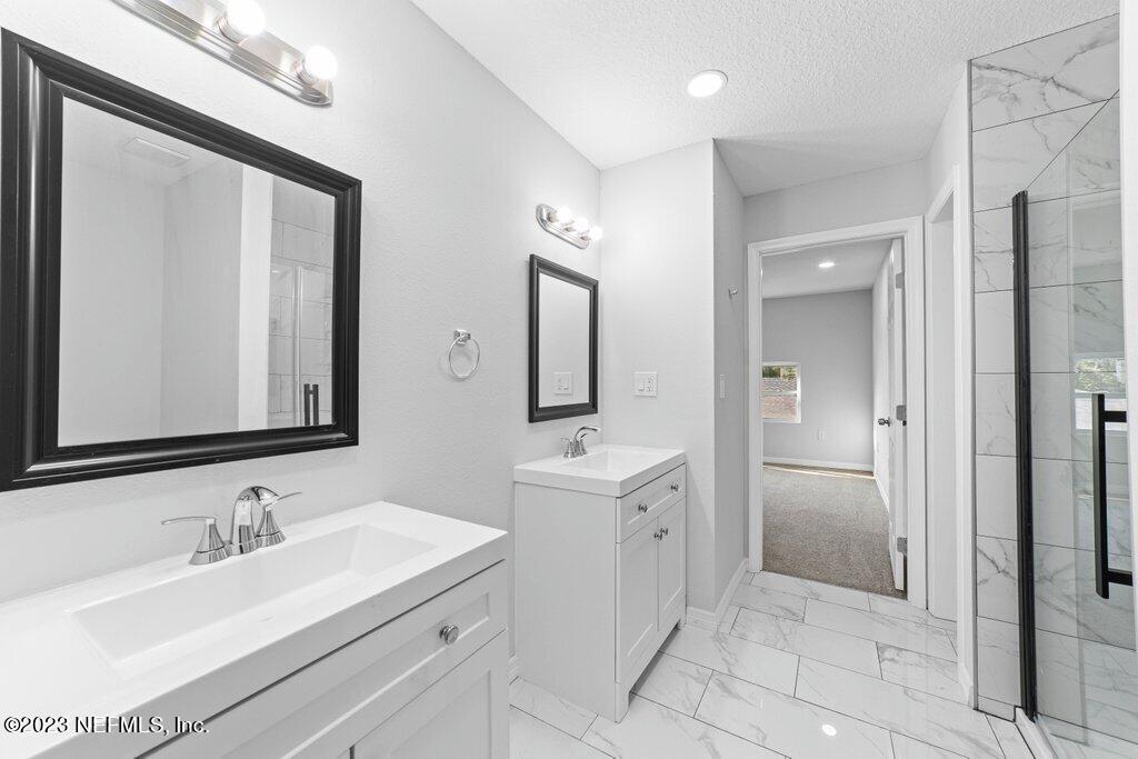 11816 Lem Turner Road Jacksonville, FL 32218 - Photo 22 of 24 a bathroom with a sink and a mirror
