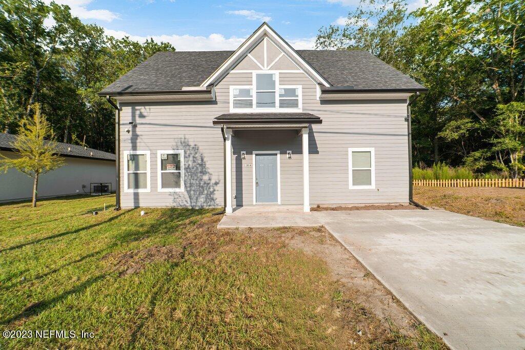 11816 Lem Turner Road Jacksonville, FL 32218 - Photo 3 of 24 a front view of a house with a yard