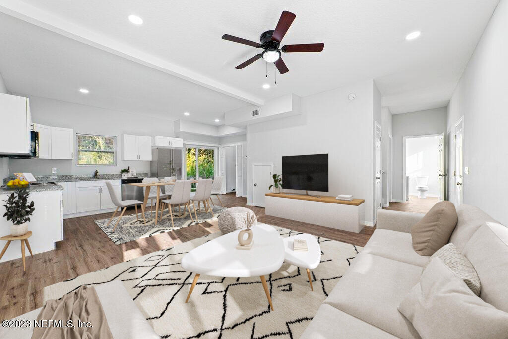 11816 Lem Turner Road Jacksonville, FL 32218 - Photo 5 of 24 a living room with furniture and a flat screen tv