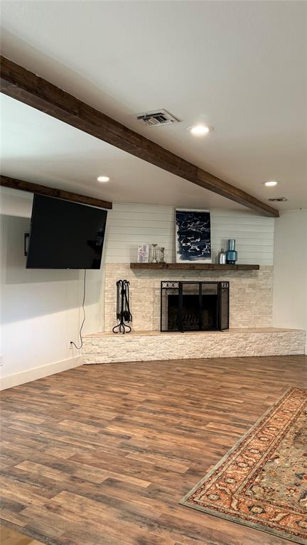 8513 Ravenswood Road Granbury, TX 76049 - Photo 5 of 21 Exposed wood beams, recessed lighting, wood-finish flooring, stone-clad fireplace with mantel, and shiplap accent wall