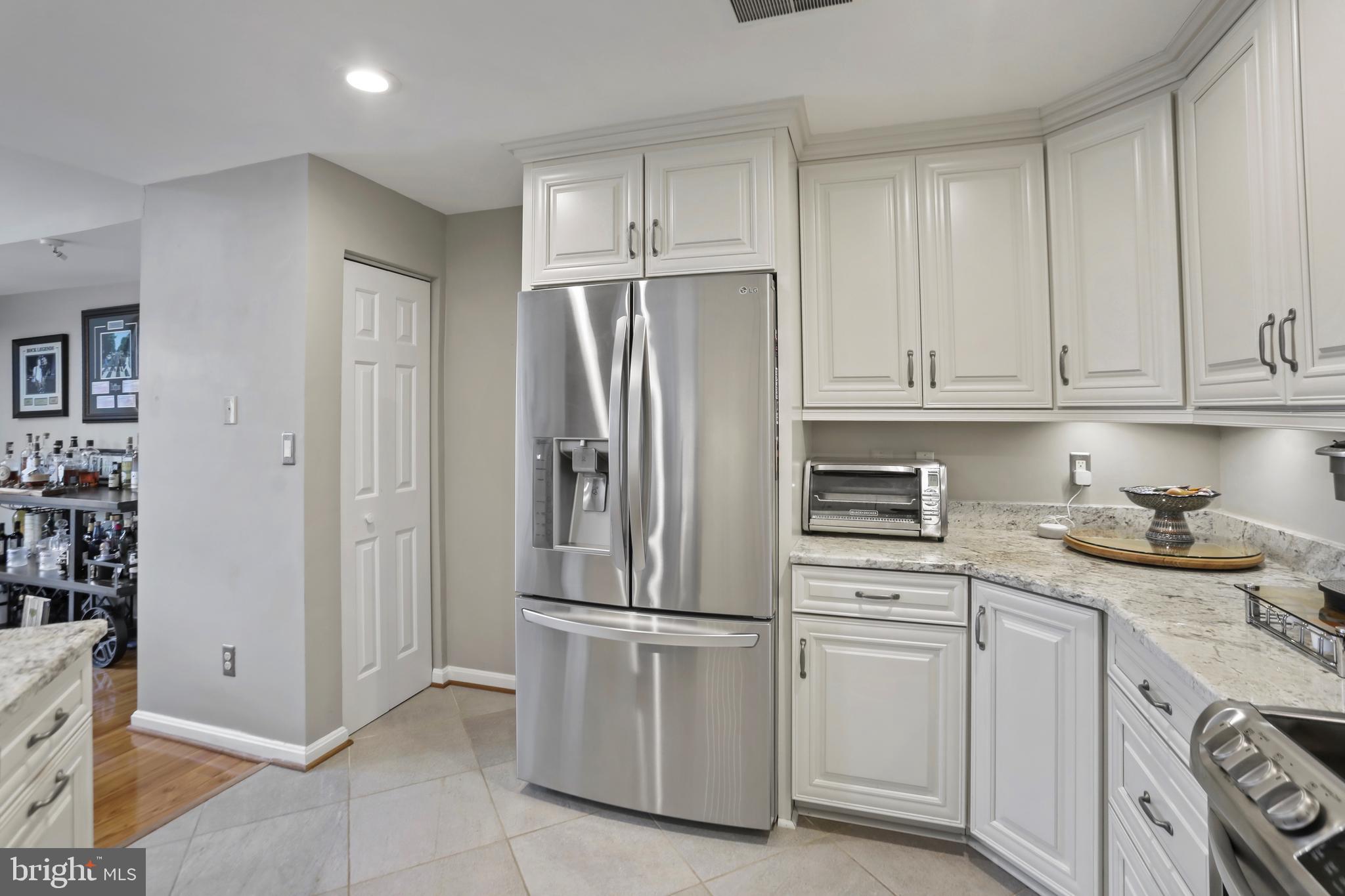 11218 Harbor Court Reston, VA 20191 - Photo 15 of 39 a kitchen with stainless steel appliances granite countertop a refrigerator sink and cabinets
