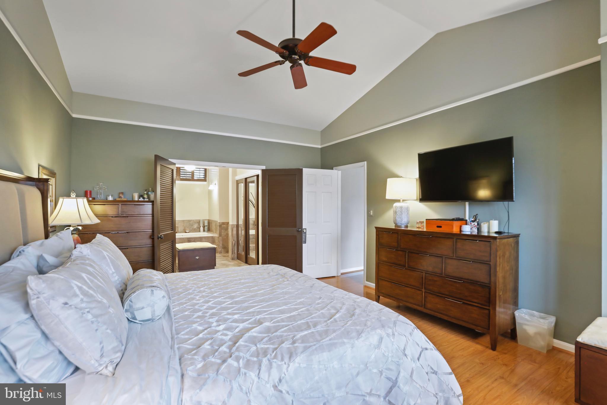 11218 Harbor Court Reston, VA 20191 - Photo 23 of 39 a bedroom with a bed and a flat screen tv