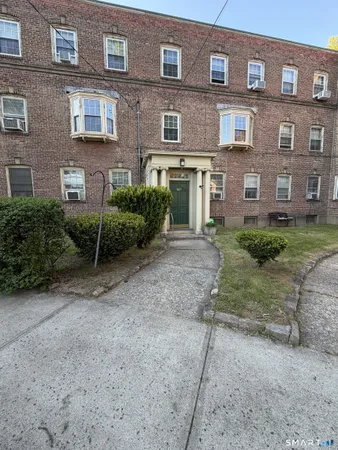a view of a brick building next to a yard