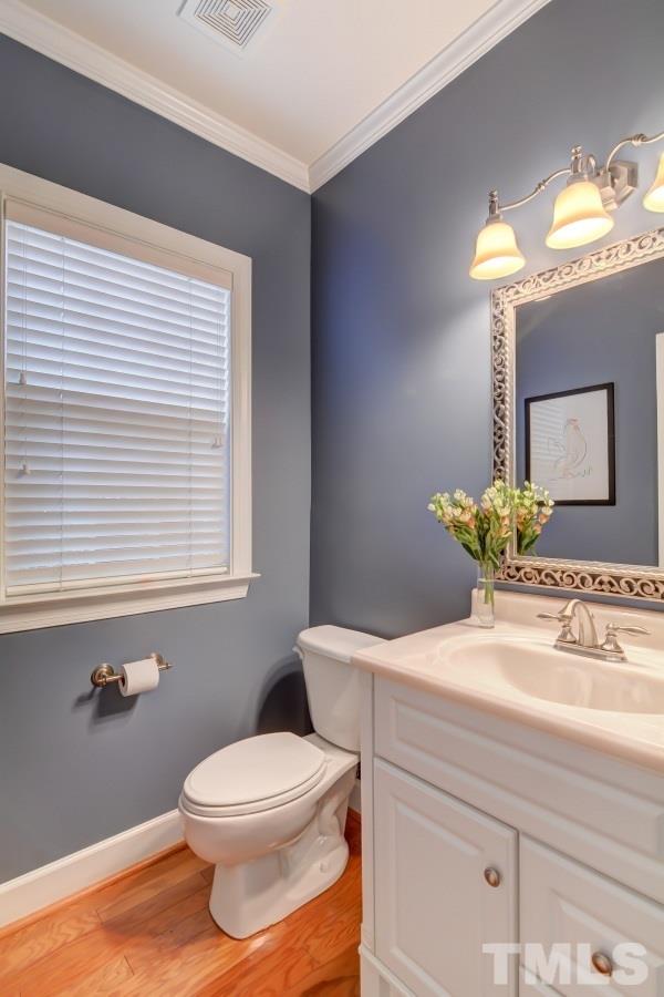 3902 Sunset Maple Court Raleigh, NC 27612 - Photo 11 of 21 a bathroom with a sink a toilet and a mirror