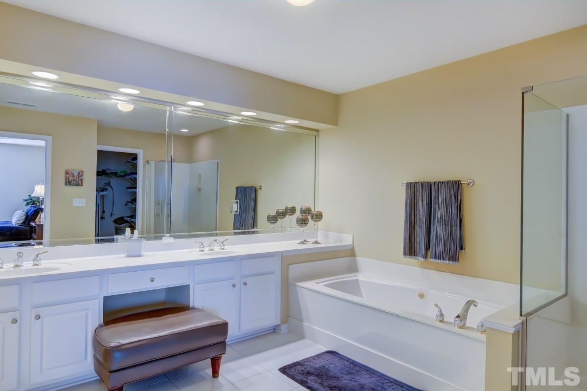 3902 Sunset Maple Court Raleigh, NC 27612 - Photo 14 of 21 a bathroom with a double vanity sink and a mirror