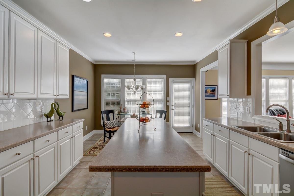 3902 Sunset Maple Court Raleigh, NC 27612 - Photo 9 of 21 a large kitchen with kitchen island a large window in it