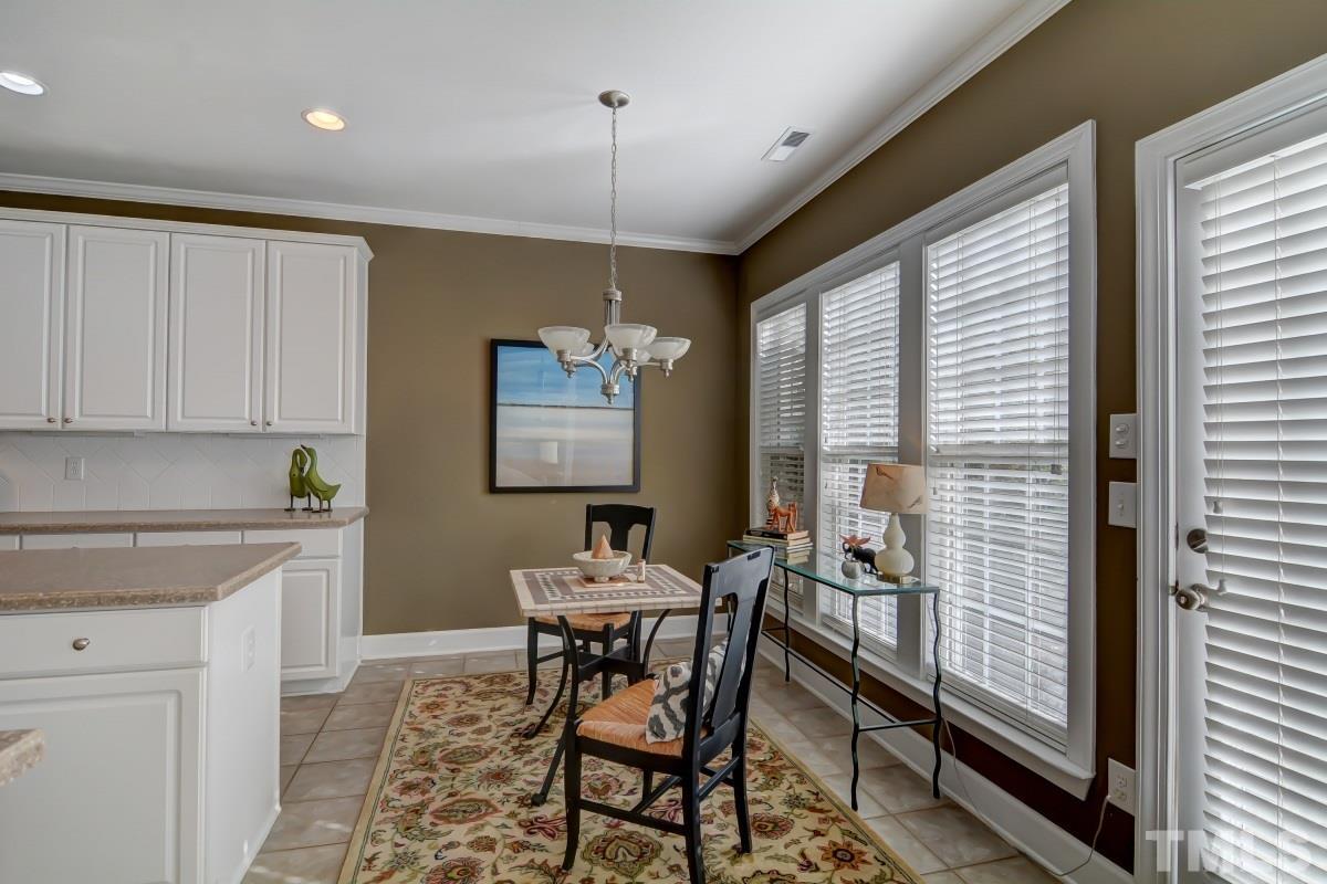 3902 Sunset Maple Court Raleigh, NC 27612 - Photo 10 of 21 a dining room with furniture and window