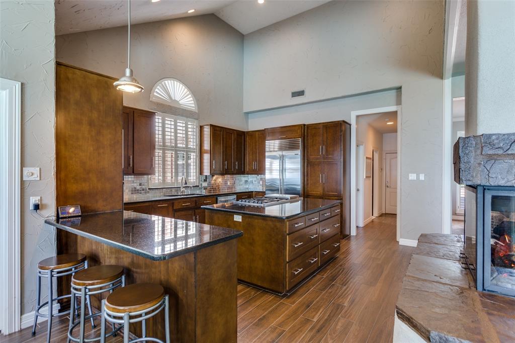 452 Windjammer Lane Azle, TX 76020 - Photo 12 of 40 a kitchen with a table chairs sink and wooden floor