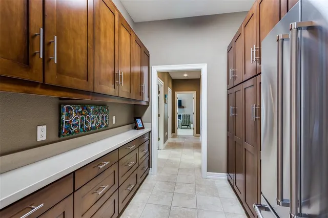 a kitchen with stainless steel appliances granite countertop a refrigerator and a sink