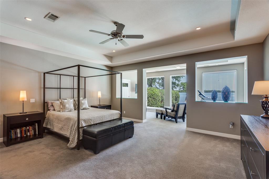 452 Windjammer Lane Azle, TX 76020 - Photo 18 of 40 a bed room with a bed and a chandelier