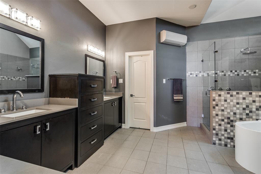 452 Windjammer Lane Azle, TX 76020 - Photo 20 of 40 a spacious bathroom with a double vanity sink a toilet a mirror and shower