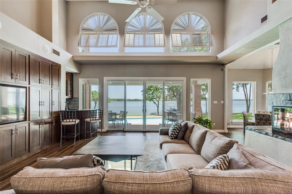 452 Windjammer Lane Azle, TX 76020 - Photo 6 of 40 a living room with furniture a large window and a chandelier