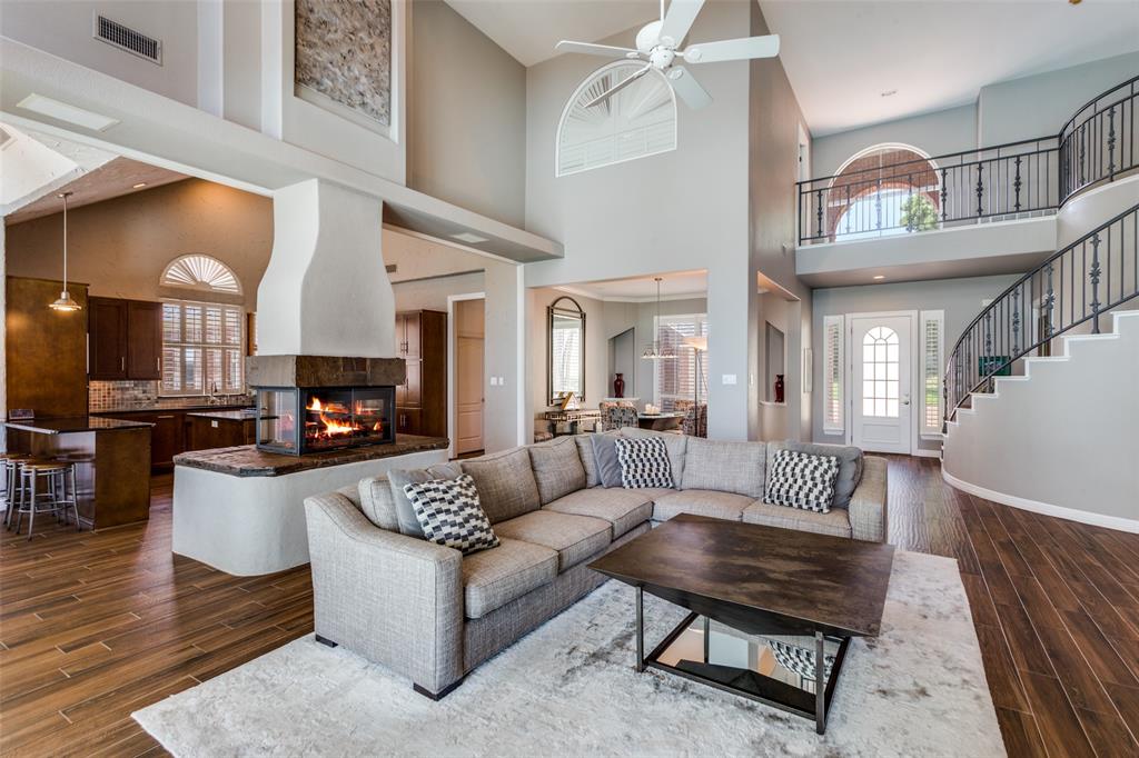 452 Windjammer Lane Azle, TX 76020 - Photo 9 of 40 a living room with furniture a fireplace and a table