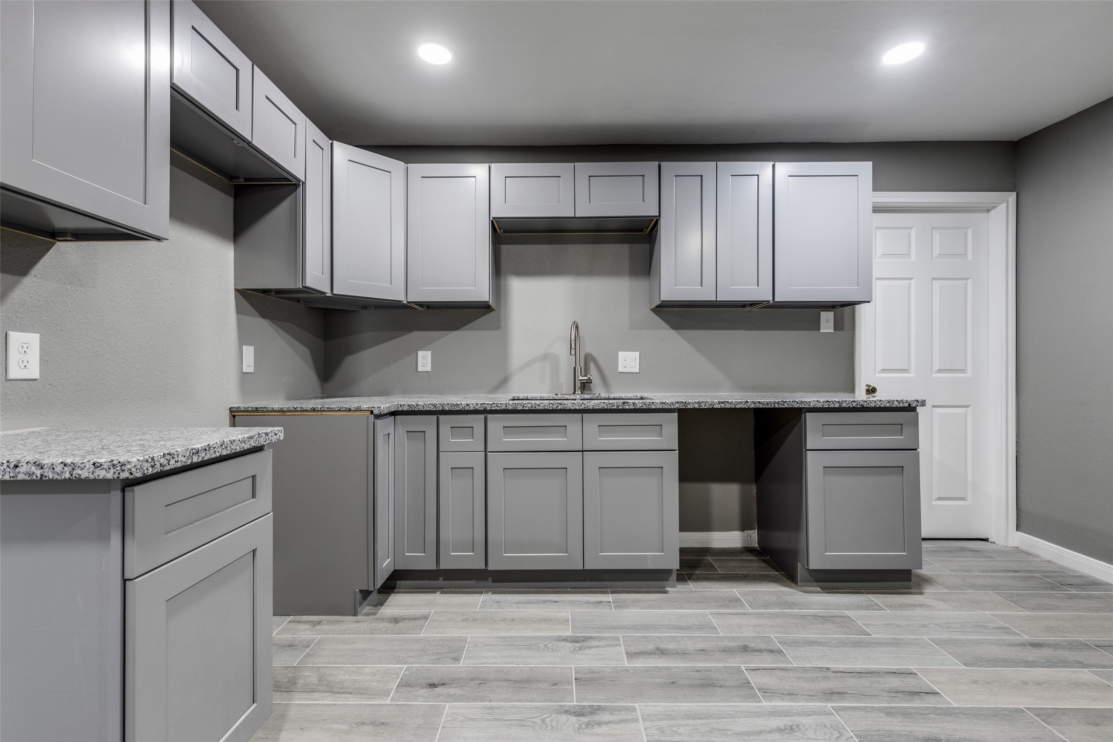 200 Pine Street Prairie View, TX 77446 - Photo 8 of 25 a kitchen with granite countertop a sink stainless steel appliances and cabinets