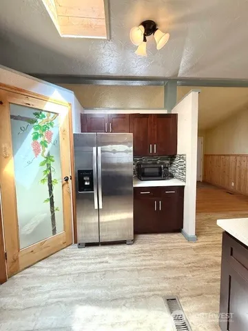 a large kitchen with kitchen island a sink stainless steel appliances and cabinets