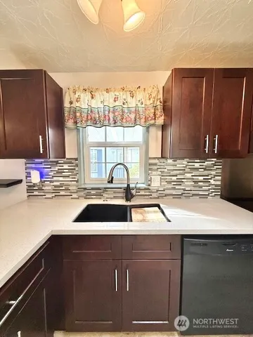 a kitchen with a stove and a sink