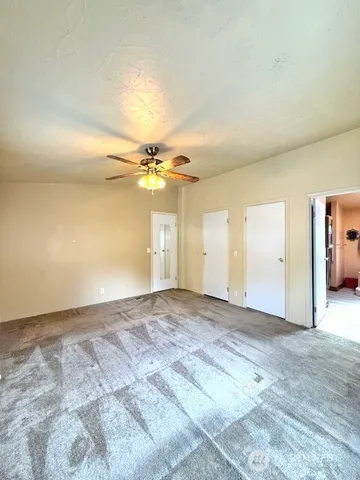a bathroom with a granite countertop double vanity and a mirror