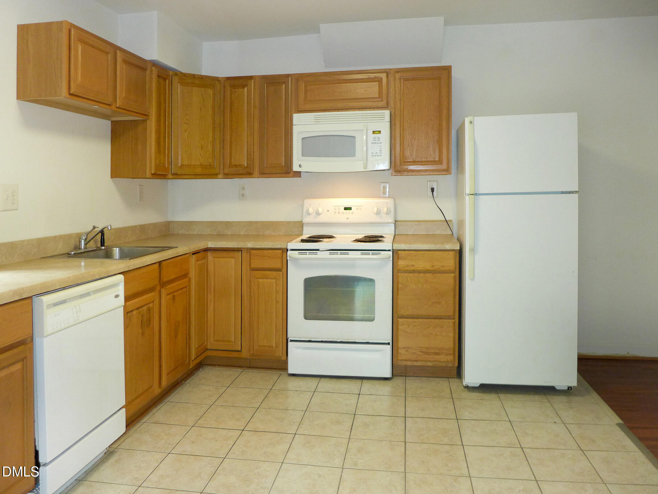 103 Ledge Lane, Unit A Chapel Hill, NC 27514 - Photo 4 of 9 a kitchen with a stove a sink and a refrigerator