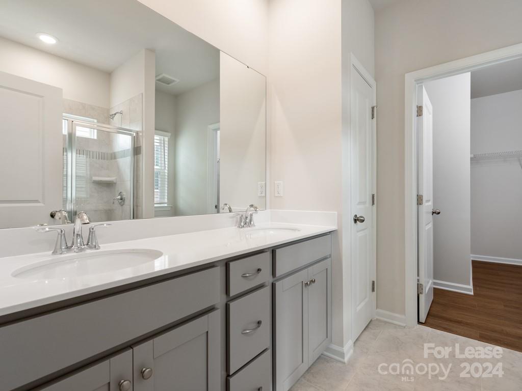6531 Gopher Road Lancaster, SC 29720 - Photo 13 of 27 a bathroom with a double vanity sink and a mirror