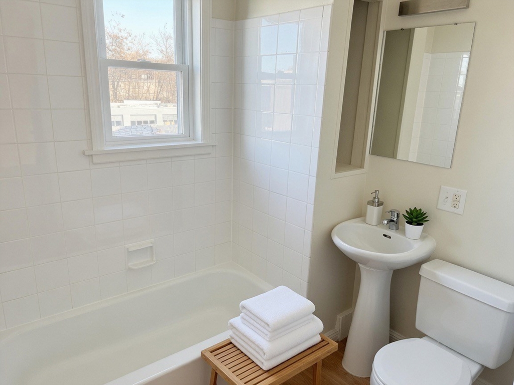 37 Madison Street, Unit 37 Malden, MA 02148 - Photo 3 of 10 a bathroom with a sink mirror bathtub and toilet