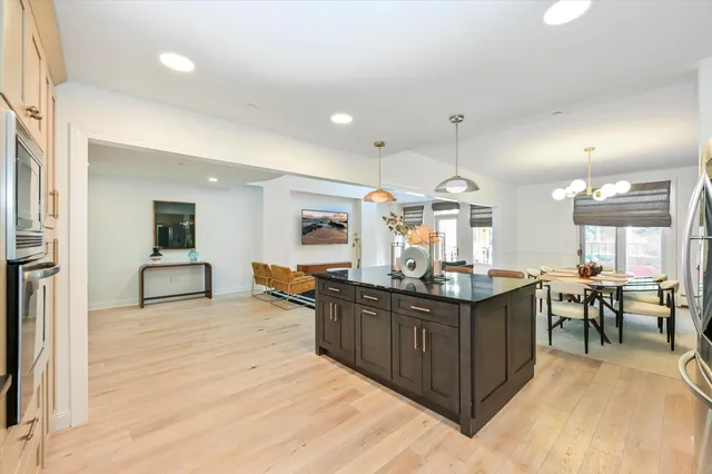 a kitchen with granite countertop a sink cabinets and wooden floor