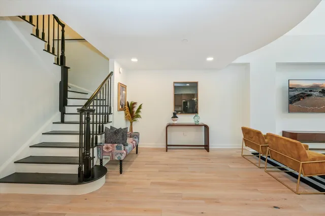 a bedroom with furniture and wooden floor