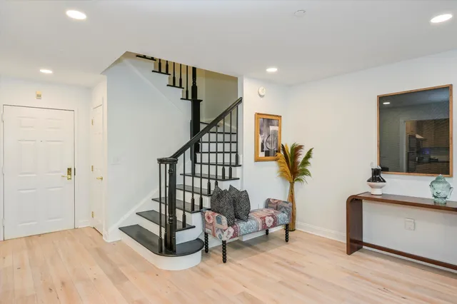 a view of entryway and hall with wooden floor