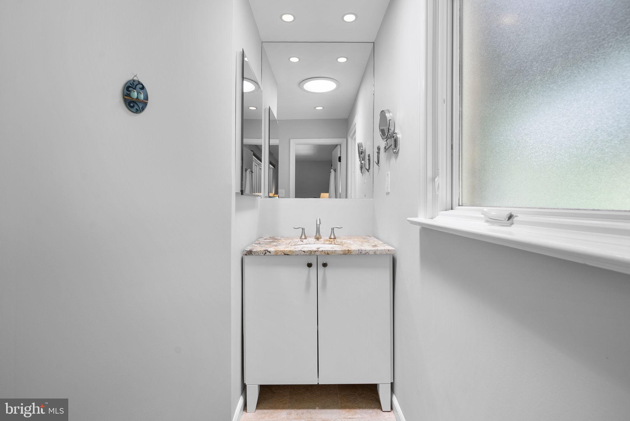 12806 Gaffney Road Silver Spring, MD 20904 - Photo 27 of 57 a bathroom with a sink a toilet and mirror