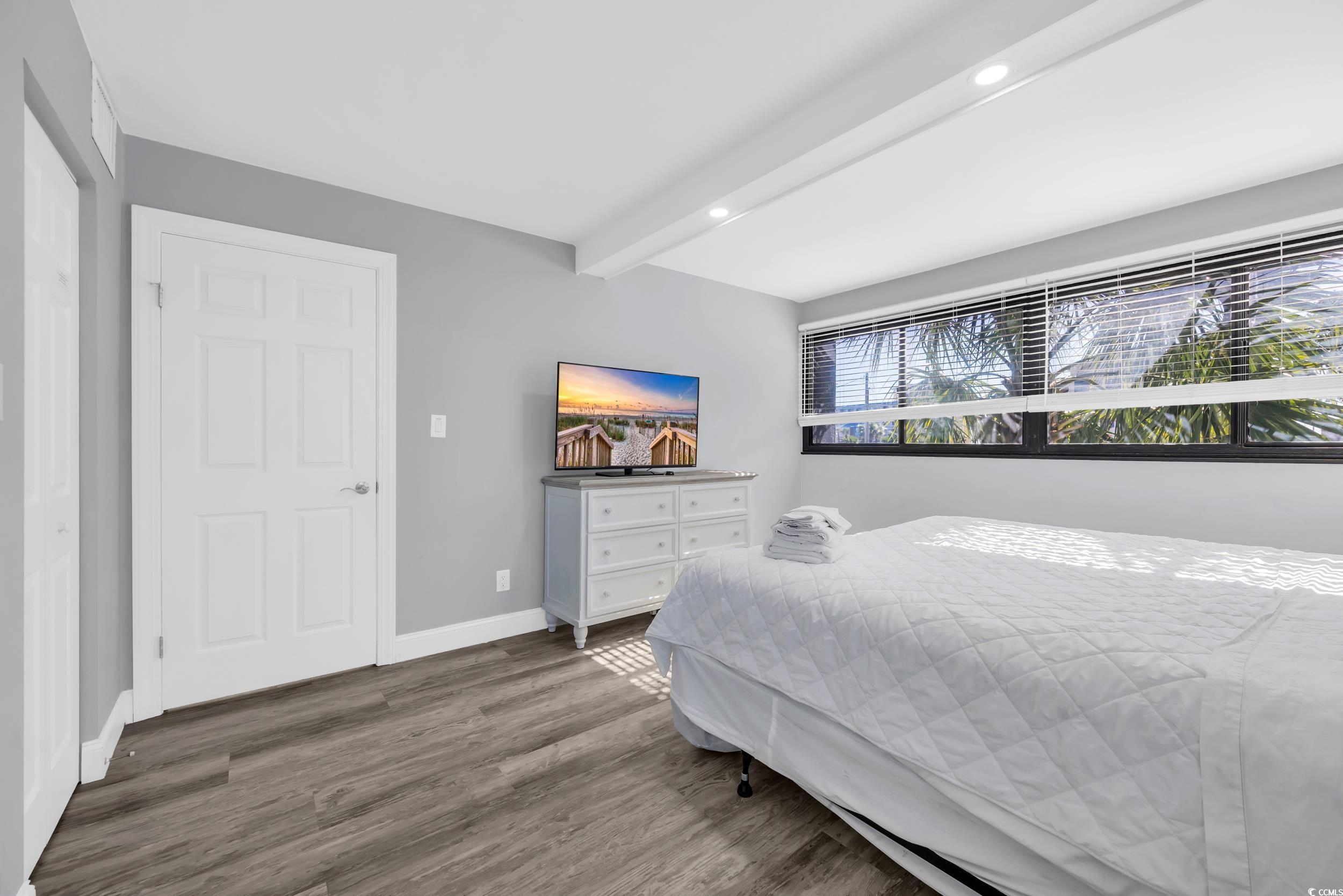 601 Mitchell Drive, Unit 203 Myrtle Beach, SC 29577 - Photo 22 of 40 Bedroom featuring beamed ceiling, wood finished floors, and recessed lighting