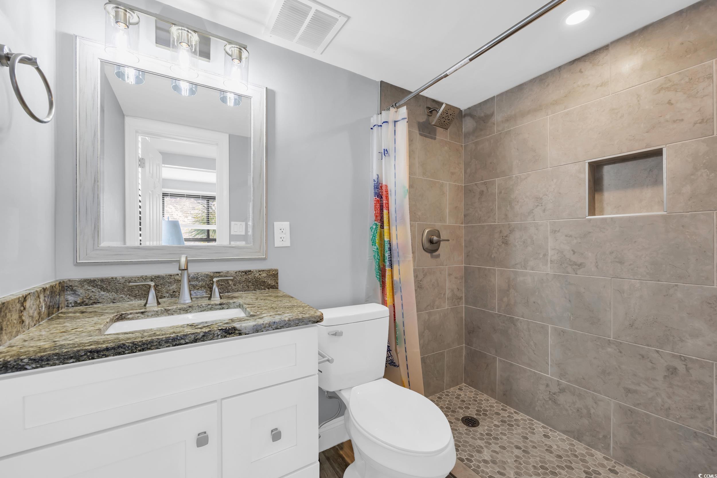 601 Mitchell Drive, Unit 203 Myrtle Beach, SC 29577 - Photo 24 of 40 Full bath with a stall shower, vanity, and recessed lighting