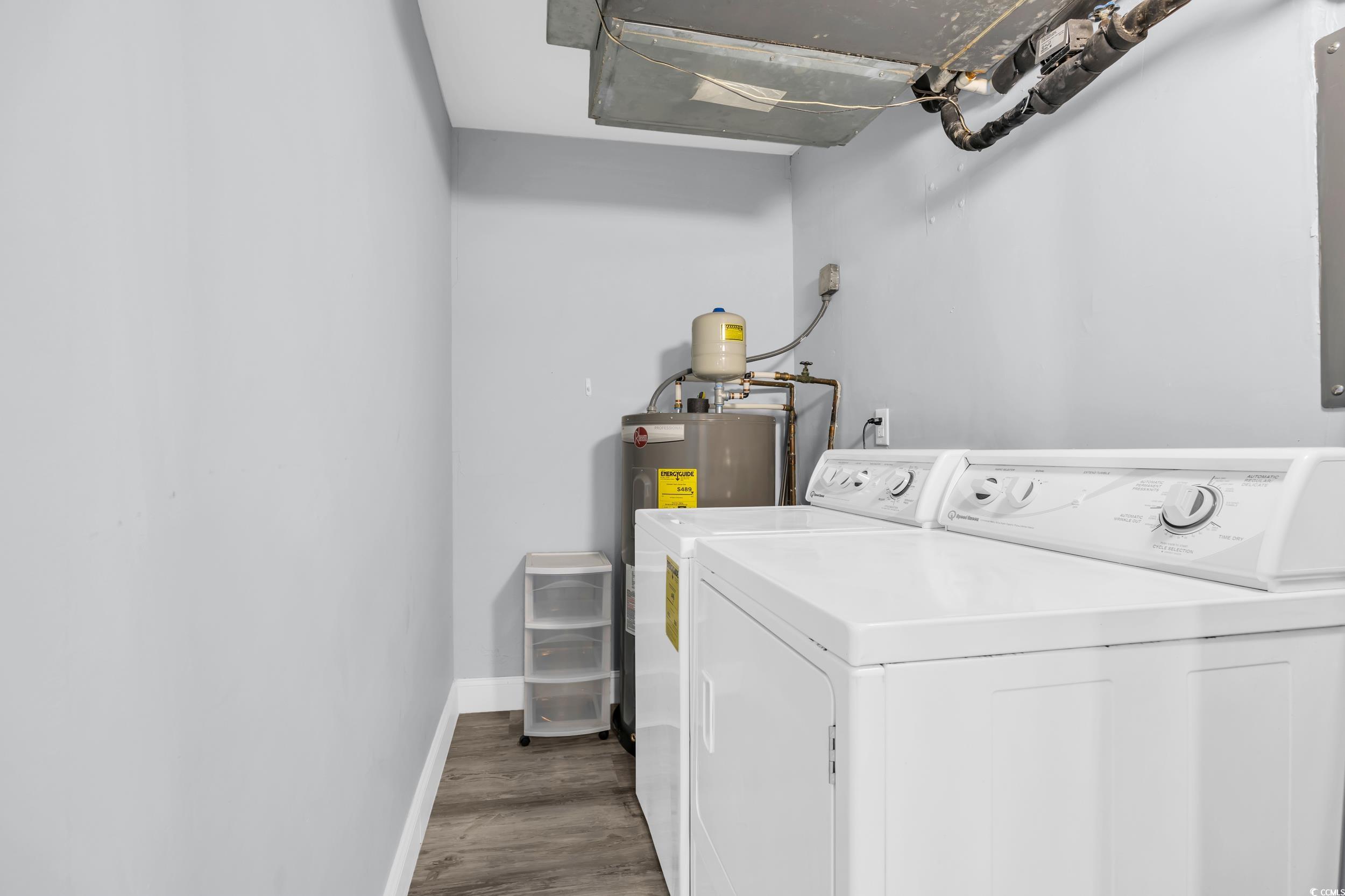 601 Mitchell Drive, Unit 203 Myrtle Beach, SC 29577 - Photo 29 of 40 Washroom featuring dark wood-type flooring and washer and clothes dryer