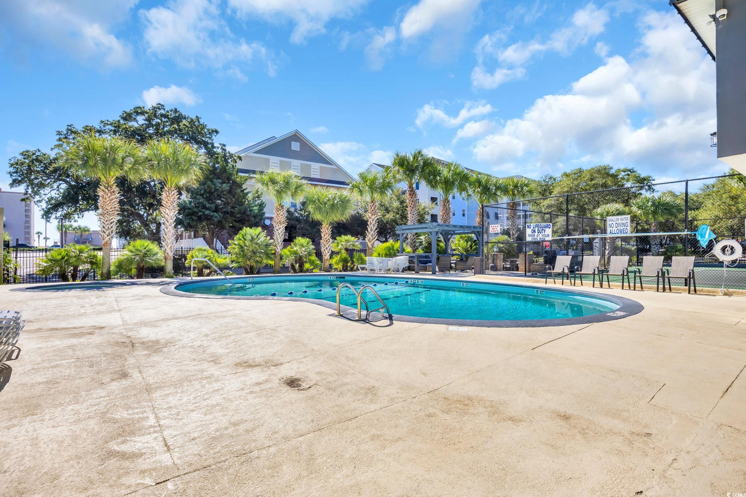 601 Mitchell Drive, Unit 203 Myrtle Beach, SC 29577 - Photo 31 of 40 Community pool featuring a patio area