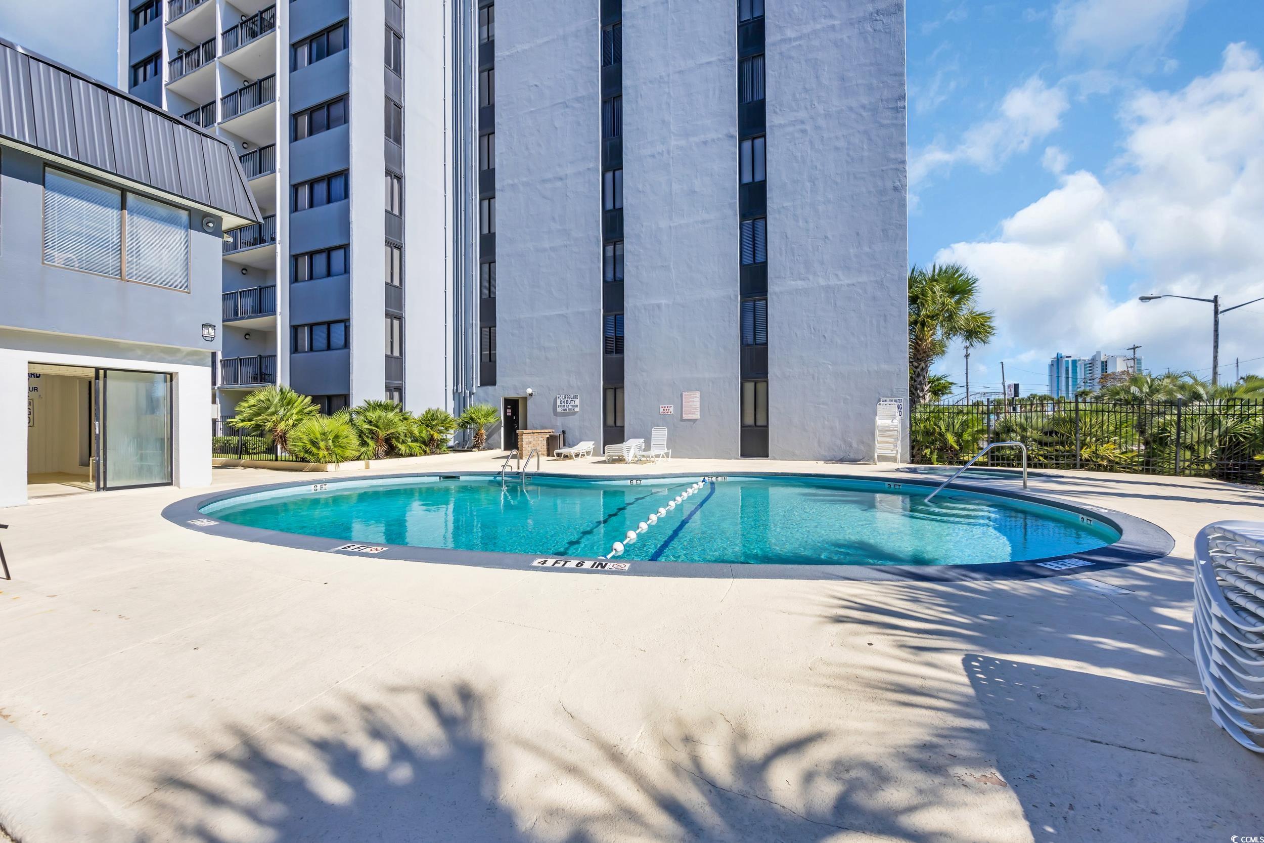 601 Mitchell Drive, Unit 203 Myrtle Beach, SC 29577 - Photo 32 of 40 Community pool with a patio