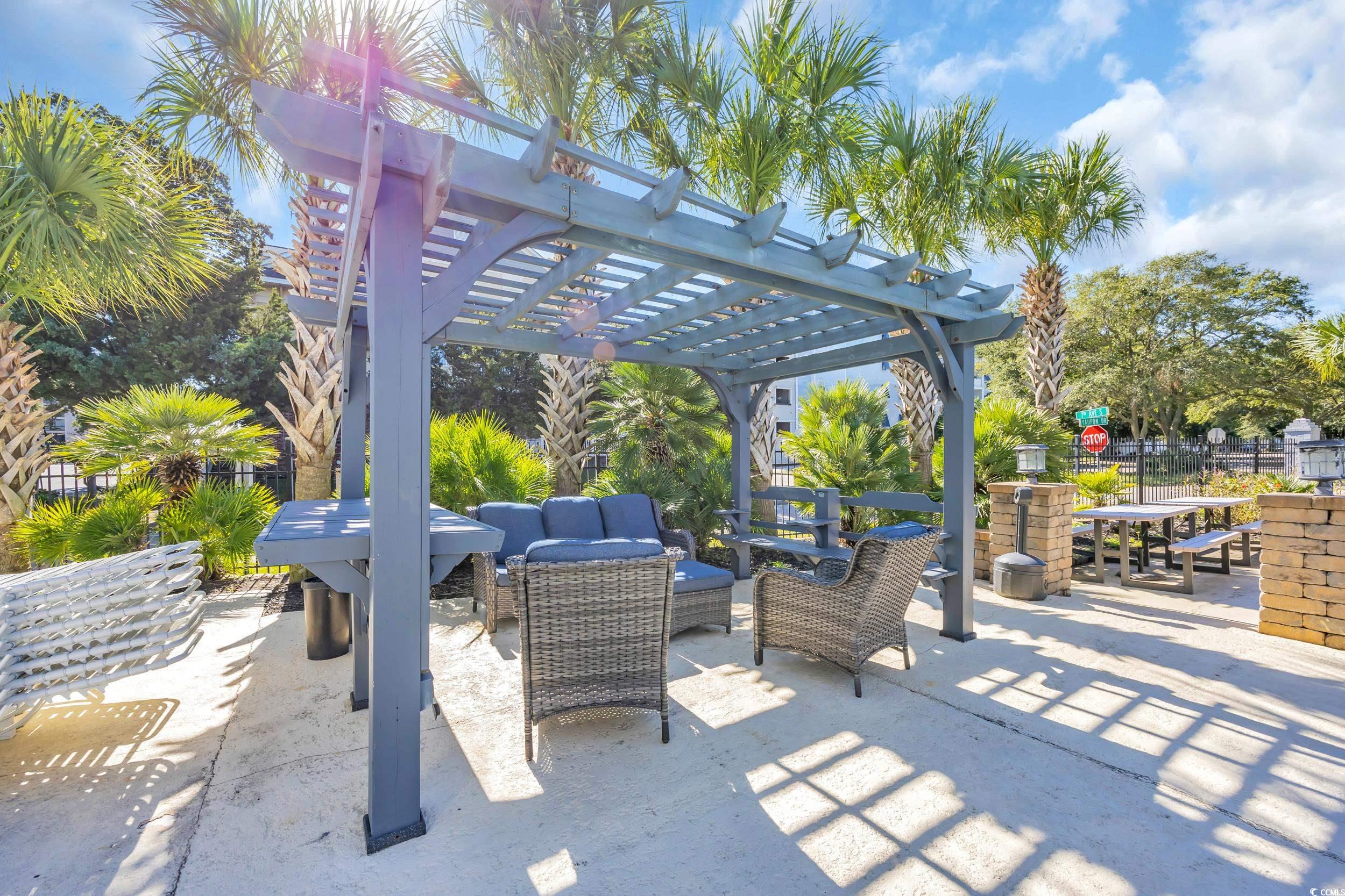 601 Mitchell Drive, Unit 203 Myrtle Beach, SC 29577 - Photo 33 of 40 View of patio / terrace featuring an outdoor hangout area, a pergola, and outdoor dining area